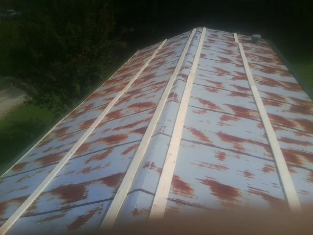 Rusted metal roof panels with new wood purlins before replacement — Storm Damage Roof Repair in Rupert by Roofing Brothers